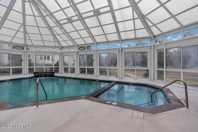 view of swimming pool with a lanai and a pool with connected hot tub