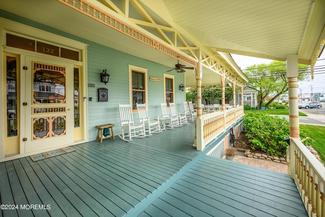 deck featuring covered porch and a ceiling fan