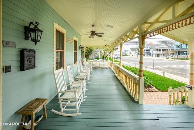 deck with a porch and a ceiling fan