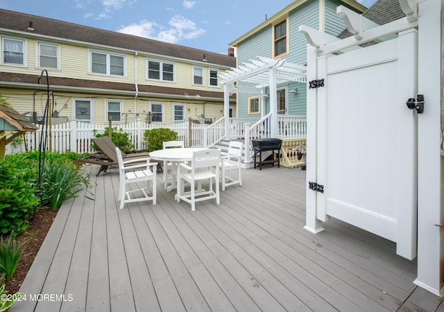 wooden terrace featuring fence and a pergola