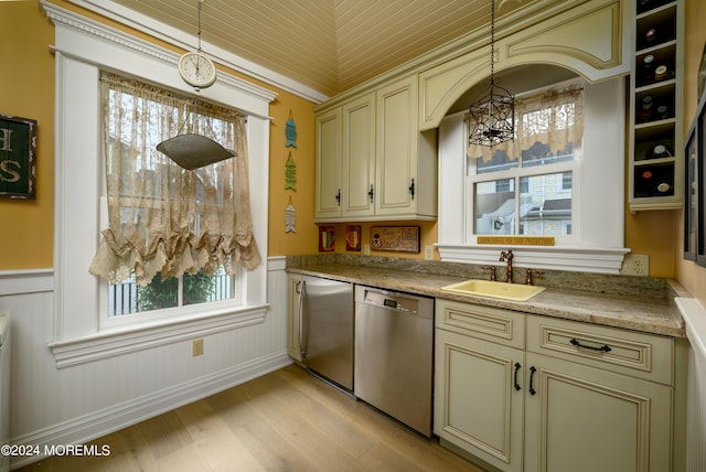 kitchen with dishwasher, hanging light fixtures, cream cabinetry, and a sink