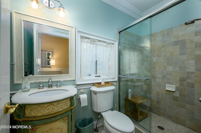 bathroom with crown molding, a shower stall, toilet, and vanity