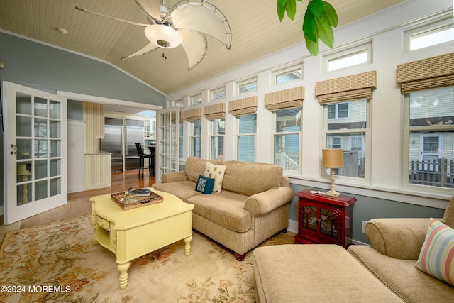 sunroom / solarium with a wealth of natural light, lofted ceiling, wooden ceiling, and ceiling fan