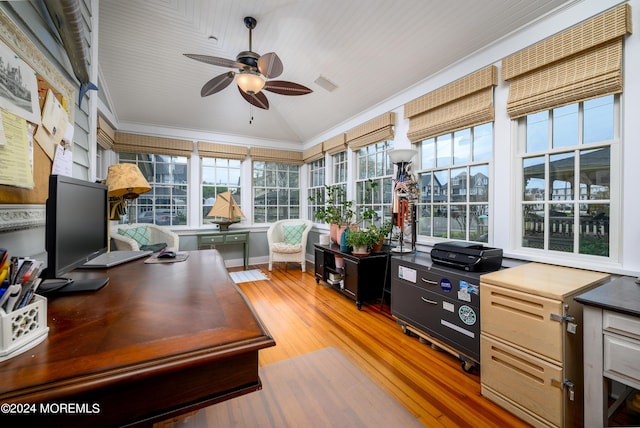 home office with lofted ceiling, wood finished floors, visible vents, and a ceiling fan