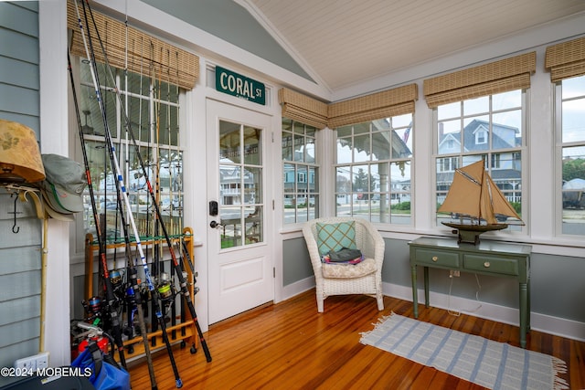 sunroom with plenty of natural light and vaulted ceiling