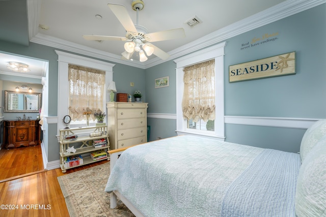 bedroom with light wood-style flooring, multiple windows, visible vents, and crown molding