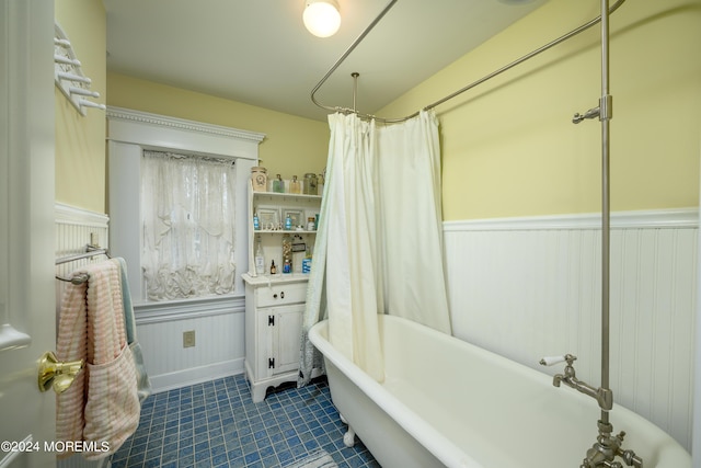 bathroom featuring wainscoting and shower / bath combination with curtain