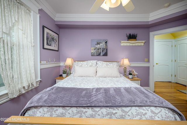 bedroom featuring a ceiling fan, crown molding, and wood finished floors