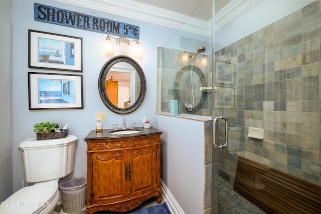 bathroom featuring toilet, a stall shower, crown molding, and vanity