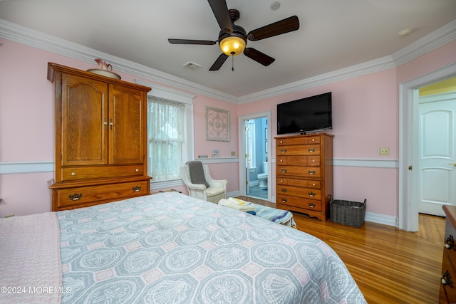 bedroom with visible vents, light wood-style flooring, ornamental molding, a ceiling fan, and connected bathroom