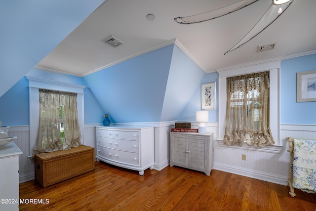 interior space featuring a wainscoted wall, visible vents, and wood finished floors