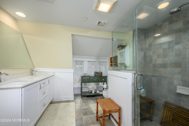 full bathroom with a stall shower, wainscoting, a sink, and visible vents