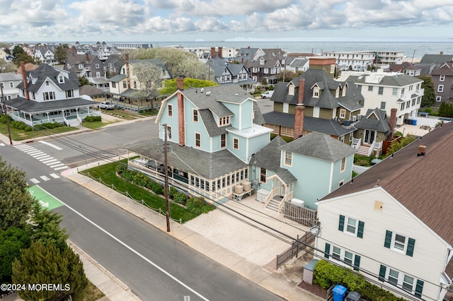 birds eye view of property with a water view and a residential view