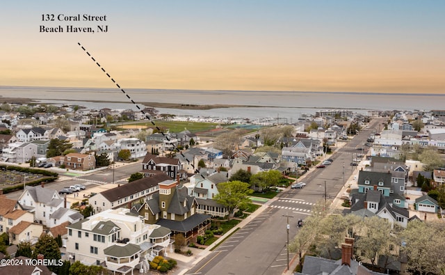 birds eye view of property with a residential view and a water view