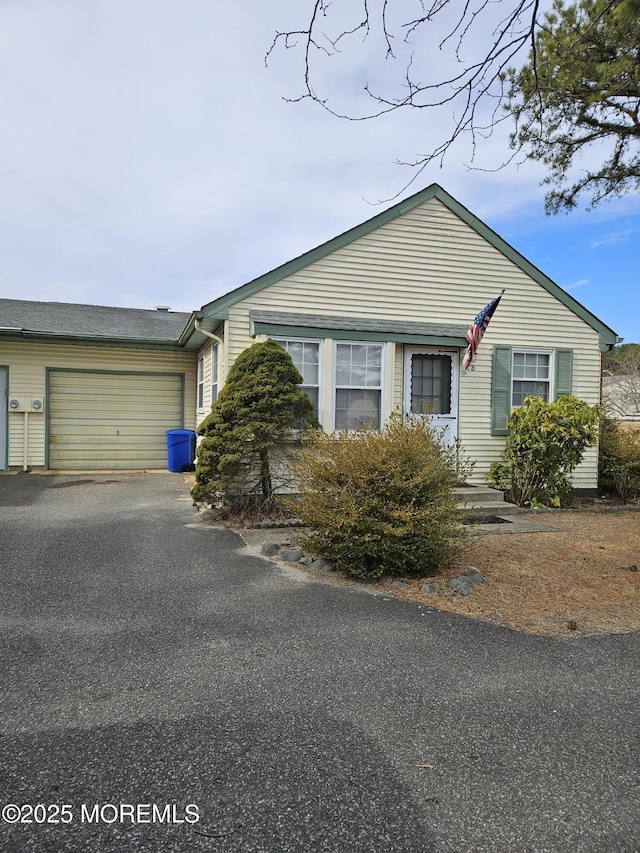 view of front of property with a garage and aphalt driveway