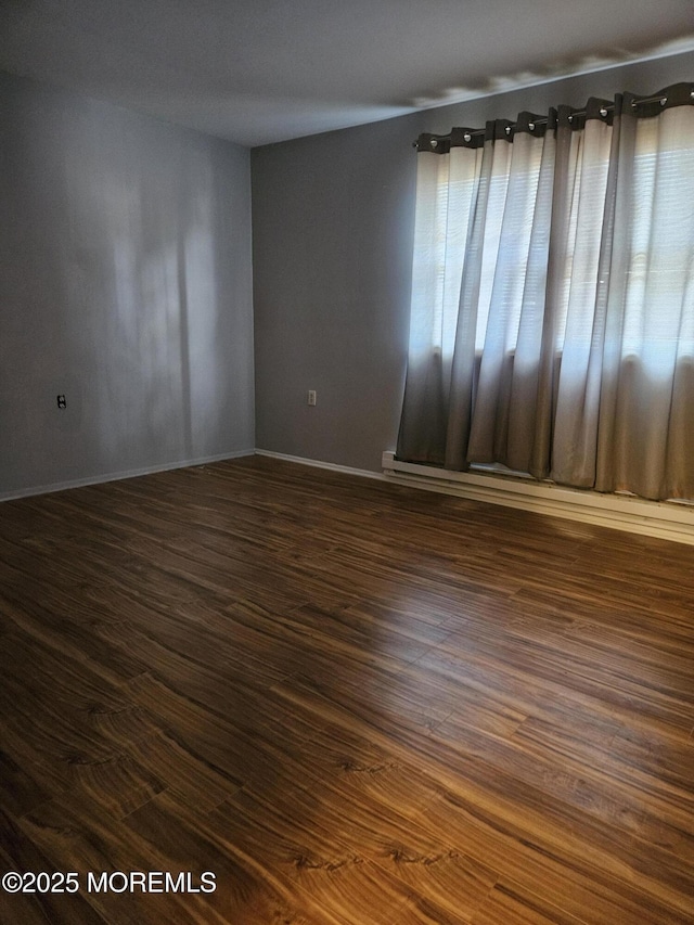 empty room featuring dark wood finished floors