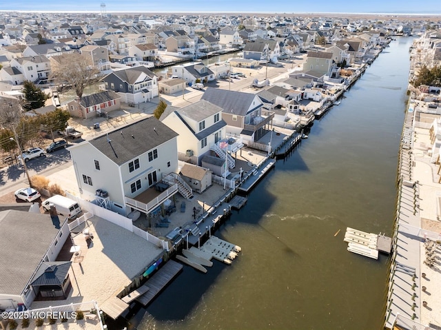 drone / aerial view featuring a residential view and a water view