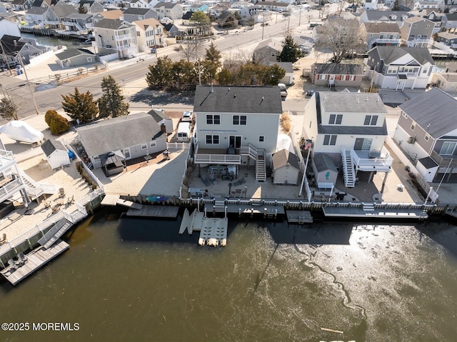 birds eye view of property featuring a residential view and a water view