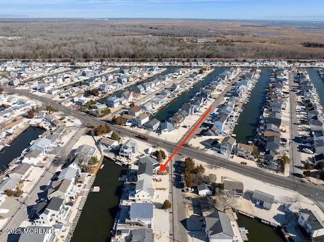 drone / aerial view with a water view and a residential view