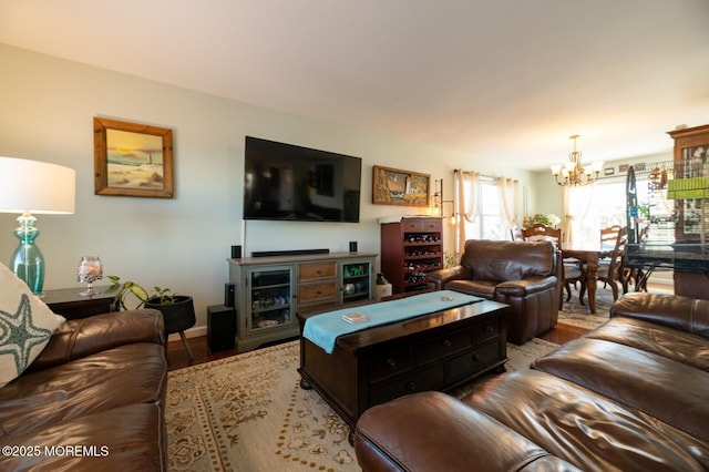 living area with light wood-style floors and a chandelier