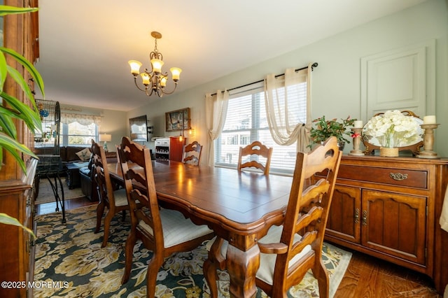 dining area with a chandelier and dark wood-style flooring