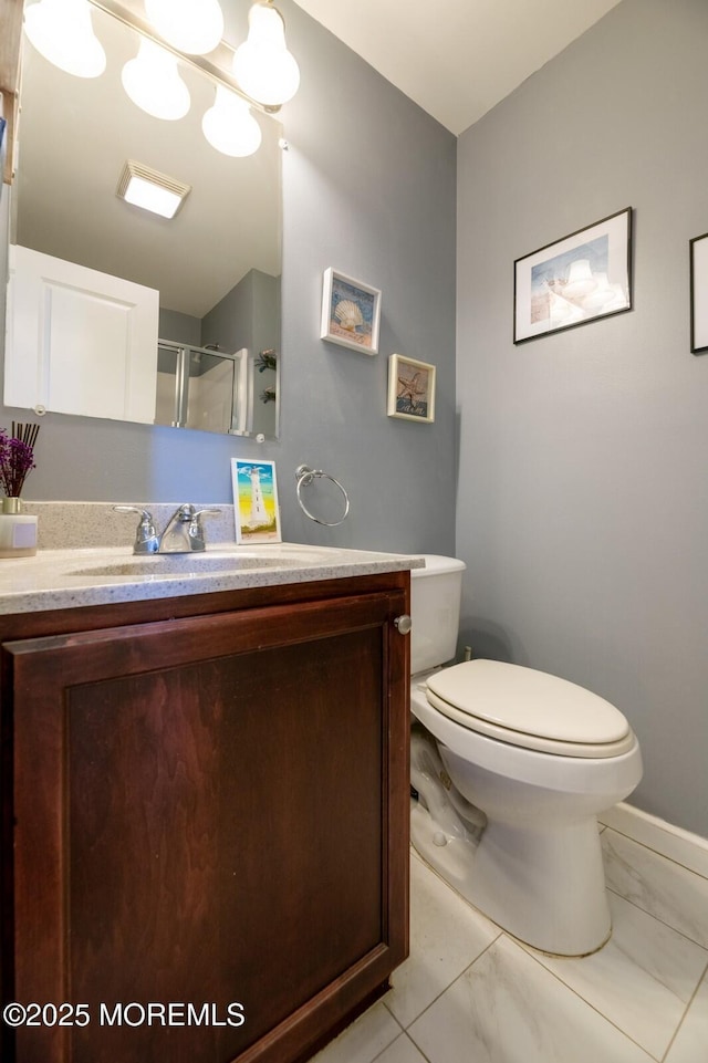 full bath with toilet, an inviting chandelier, marble finish floor, an enclosed shower, and vanity