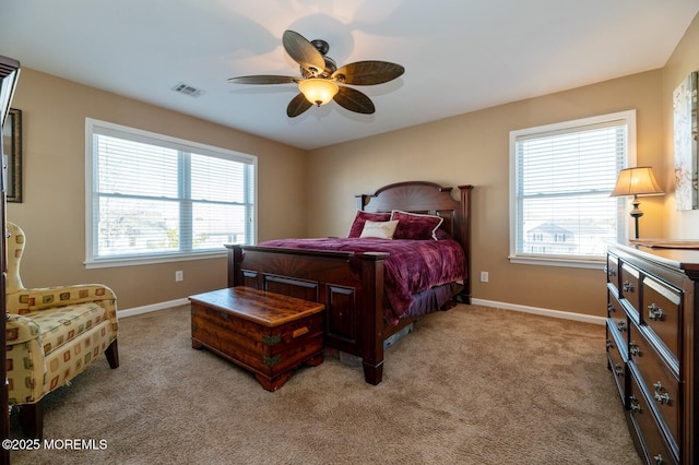 bedroom featuring light carpet, baseboards, visible vents, and a ceiling fan