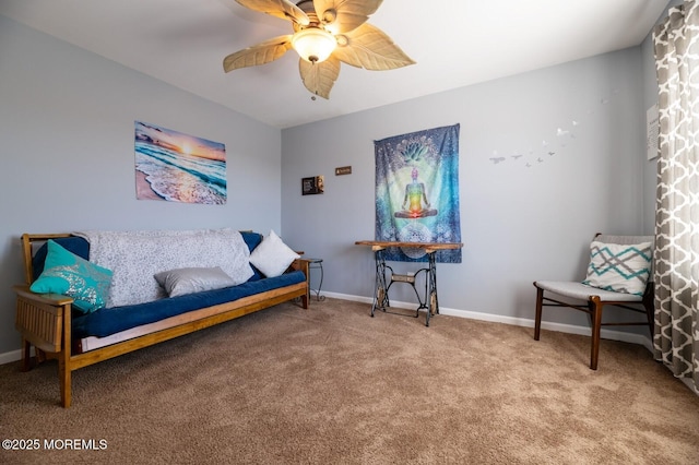 sitting room featuring ceiling fan, carpet flooring, and baseboards