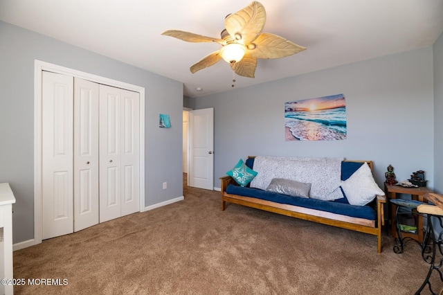 living area featuring baseboards, a ceiling fan, and carpet flooring