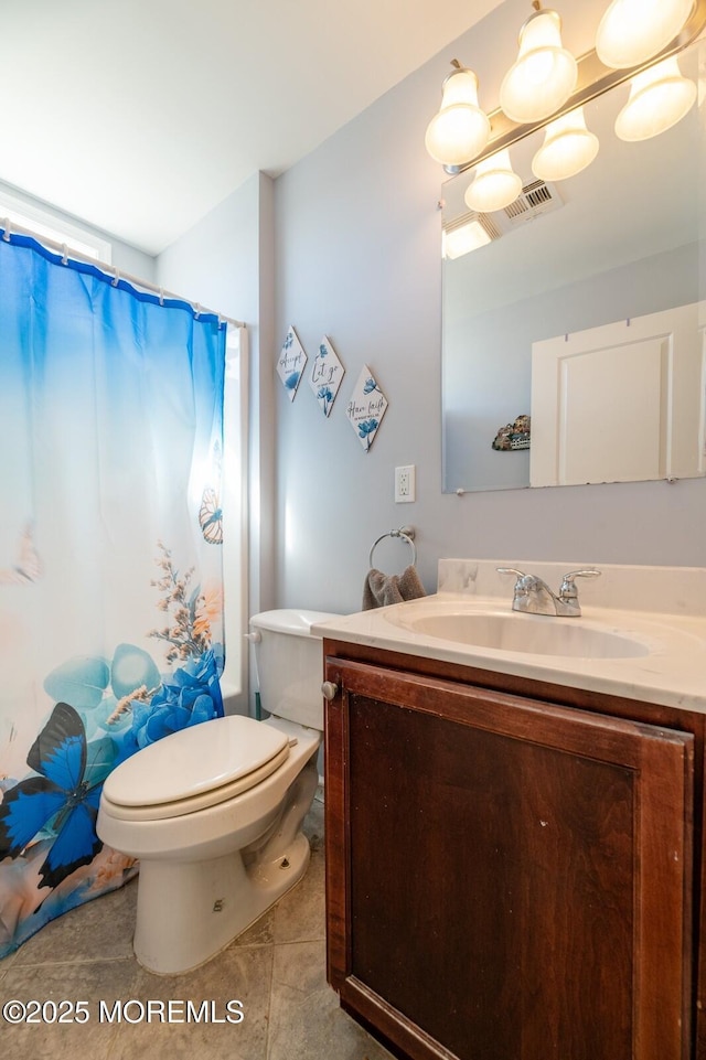 bathroom with visible vents, vanity, tile patterned flooring, and toilet