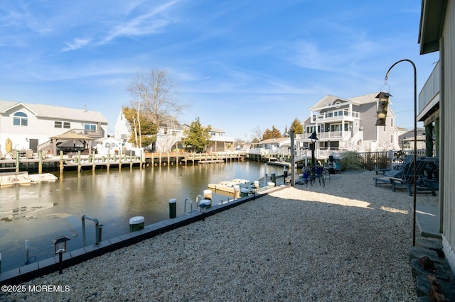 view of dock featuring a residential view and a water view