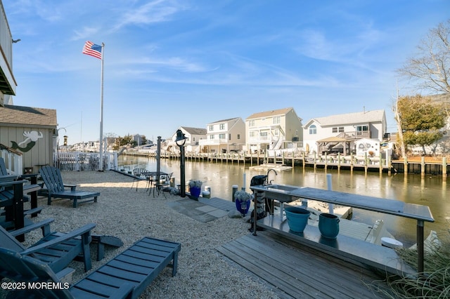 view of dock featuring a residential view and a water view