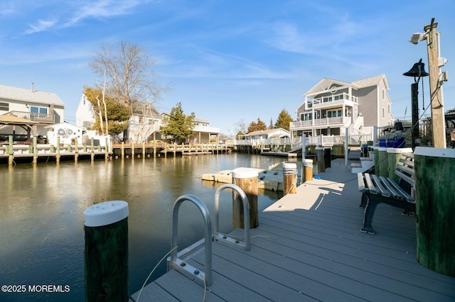 dock area with a residential view and a water view