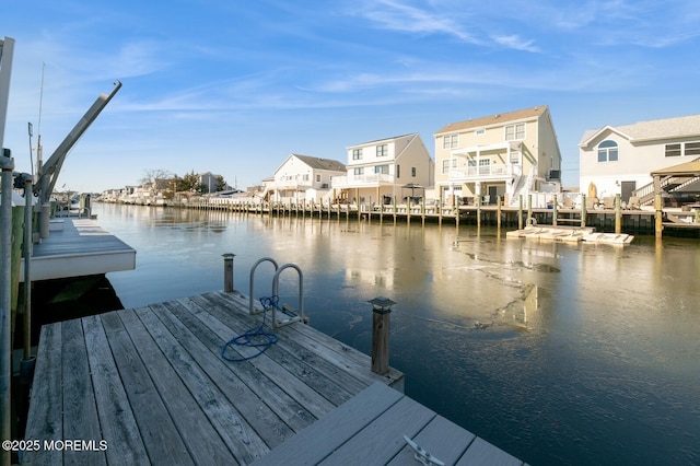 view of dock with a water view and a residential view