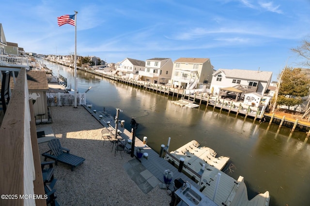 view of water feature featuring a dock and a residential view