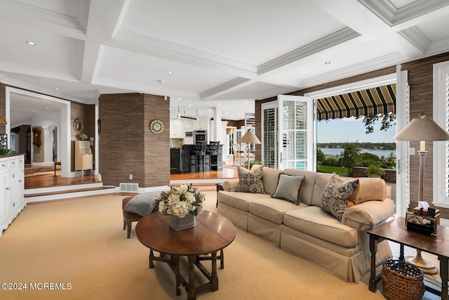 living area with coffered ceiling, light colored carpet, beam ceiling, and visible vents