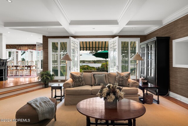 living room featuring coffered ceiling, a healthy amount of sunlight, and beamed ceiling