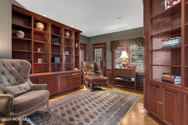 living area with wainscoting and light wood-style flooring