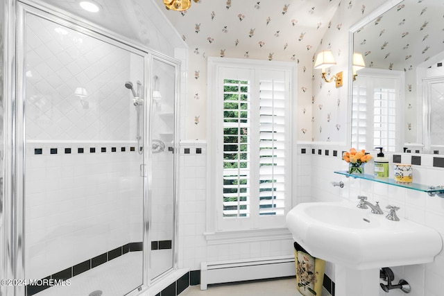 full bathroom featuring wallpapered walls, a stall shower, a wainscoted wall, baseboard heating, and tile walls