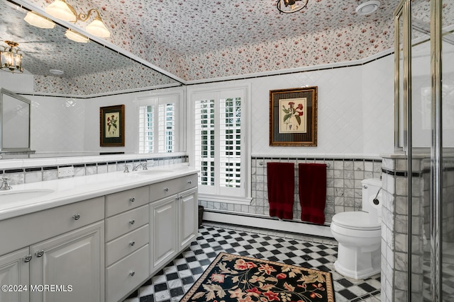 bathroom with double vanity, a sink, tile walls, and tile patterned floors