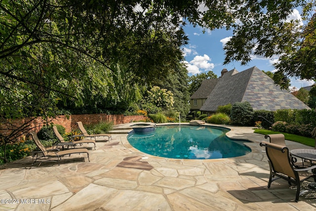 view of swimming pool featuring a patio area, fence, and a fenced in pool