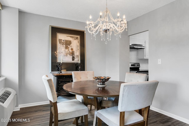 dining area featuring a textured ceiling, baseboards, and dark wood-style flooring