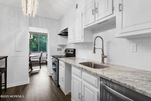 kitchen featuring light stone counters, under cabinet range hood, a sink, white cabinets, and appliances with stainless steel finishes