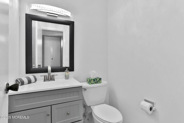 bathroom with toilet and vanity