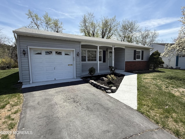 ranch-style house featuring driveway, covered porch, a front yard, and a garage