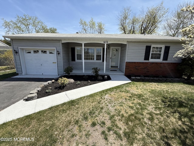 ranch-style house featuring driveway, an attached garage, a porch, a front yard, and brick siding