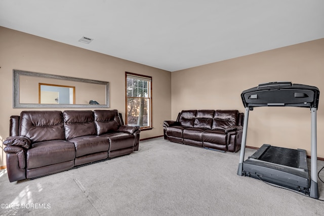 carpeted living area with baseboards