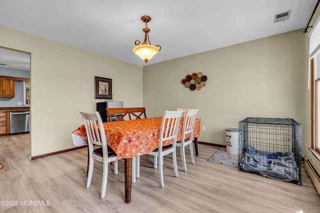 dining room with visible vents, light wood-style flooring, and baseboards