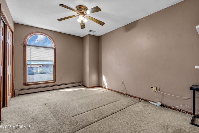 unfurnished room featuring visible vents, a baseboard heating unit, a ceiling fan, and light colored carpet