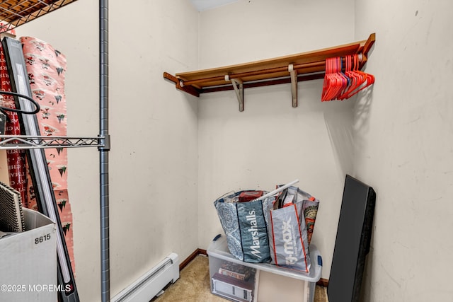 interior space featuring a baseboard heating unit and carpet flooring